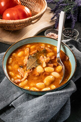 Beans with tomato sauce, bacon and sausage.