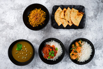 Set of Asian food: rice with stew and vegetables, lentil soup puree and Naan flatbread, restaurant menu.