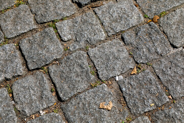 Cobblestones cover road or pavement surface