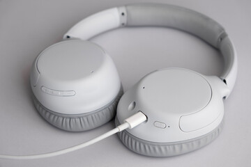 New and modern headphones charging on a table