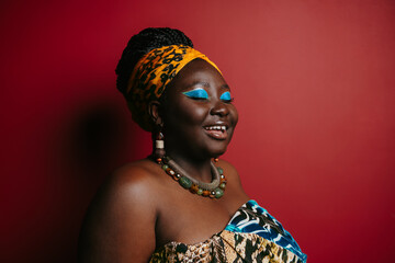 Gorgeous plus size African woman with beautiful make-up wearing traditional headwear 