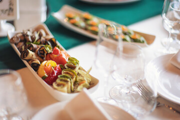 salmon, lined on a white plate. Close-up. Celebration dinner wedding food table. The banquet table. Tableware. Food, snacks, fish, olives, vegetables. Breakfast buffet in the hotel. Restaurant.