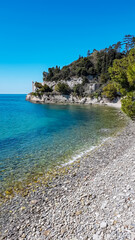 Scenic view of beautiful sand beach along the coastline of the golf of Trieste in Friuli-Venezia Giulia, Italy, Europe. Blue sky in tranquil atmosphere at Adriatic Mediterranean sea in summer