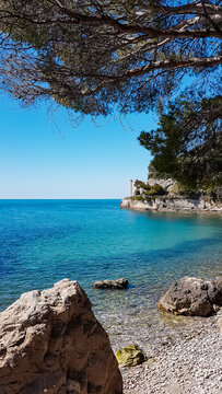 Scenic view of beautiful sand beach along the coastline of the golf of Trieste in Friuli-Venezia Giulia, Italy, Europe. Blue sky in tranquil atmosphere at Adriatic Mediterranean sea in summer