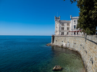 Fototapeta na wymiar Scenic view of majestic historic white Miramare castle in Trieste in Friuli-Venezia Giulia, Italy, Europe. Blue sky in tranquil atmosphere at Adriatic Mediterranean sea in summer. Sightseeing