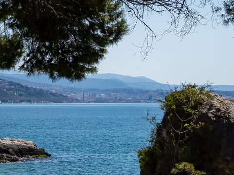 Scenic view of beautiful sand beach along the coastline of the golf of Trieste in Friuli-Venezia Giulia, Italy, Europe. Blue sky in tranquil atmosphere at Adriatic Mediterranean sea in summer