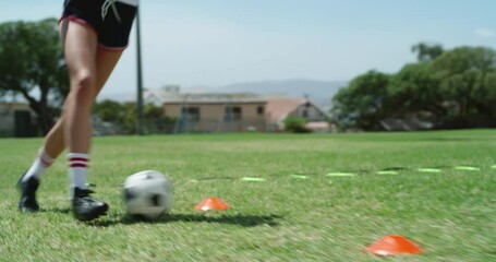 Woman, legs and feet practice in soccer on green grass field for sports training, dribbling or goal. Closeup of female person, athlete or football player in drill course, stepping and ball in fitness