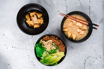 Fried tofu with honey, Dan Dan noodles with minced pork and braised chicken with tofu with chopsticks.