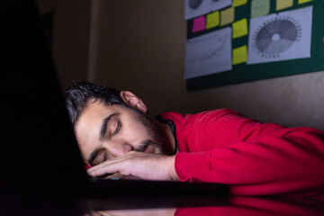 male sleeping on his desk during working
