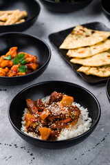 Pork with basmati rice and pineapple, spicy chicken fillet with chili and Naan flatbread with cilantro.