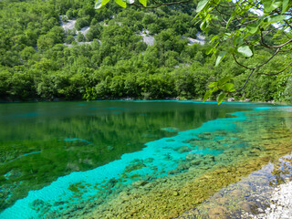 Scenic view of turquoise colored Lake Cornino near Udine in Friuli-Venezia Giulia, Italy, Europe. Peaceful serene scene on Alpe Adria trail in Italian Alps. Calcium sulphate gypsum in water. Awe