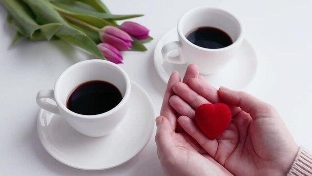 Green screen chroma key tulips two coffee cups small red heart in woman's hands spring holidays Valentines day