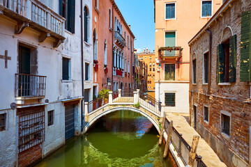 Grand Canal, Venice (Venezia, Italy. Antique bridge over canal among traditional medieval Venetian houses view of old town. Sunny summer day. Famous and popular travel destination. - 694550778