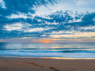 Fototapeta na wymiar Sunrise at the seaside with clouds