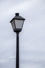 Vintage Street Lamp against Gloomy Clouded Sky