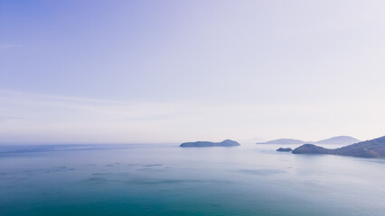 Aerial view of blue water surface background and sun reflection. aerial view of a flying drone Waves surface on a tropical ocean with bright sunlight. Perfect for vacations, in the island of Phuket 