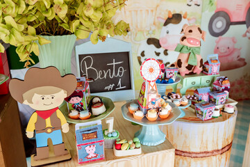 a farm birthday decoration with sweets and farm trinkets