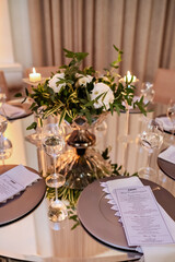 a round table with a glass top and a porcelain serving set with crystal glasses