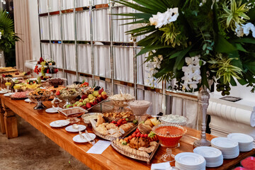 a buffet table decorated with fruits, meats and cheeses