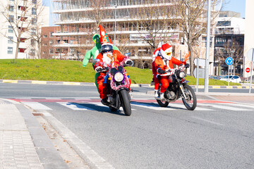 alien santa claus handing out gifts in Moto Noel Navarra, Spain. Day 17/12/2023 christmas holidays