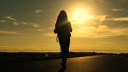 girl traveling with backpack sunset, family sun, hiking girl asphalt road, attractive happy young...