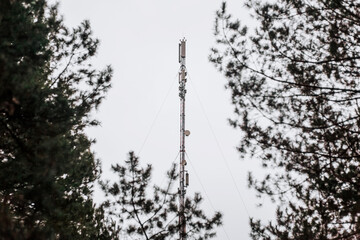 A tall telephone tower for communication, the Internet, with antennas on the structure stands...