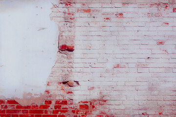 White and blue plaster on a dilapidated brick wall. Preparing the wall for repairs. Can be used as...