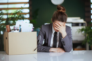 stressed modern woman worker in modern green office