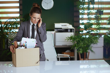 concerned modern female employee in modern green office