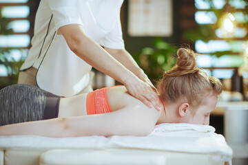 female massage therapist in massage cabinet making massage - obrazy, fototapety, plakaty