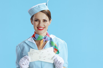 smiling modern female air hostess on blue