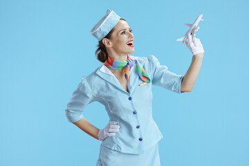 happy modern flight attendant woman on blue