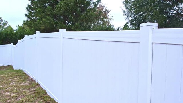 footage of white fencing in a residential backyard
