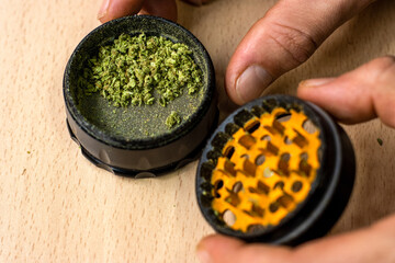recognizable person preparing a marijuana joint