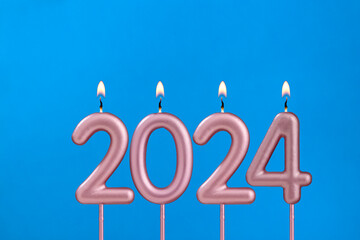 Happy new year 2024 candles - Cupcake on blue background with balloons