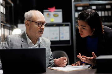 Administrative management coworking businessmen discussing accountancy market database information. Invoicing paperwork in archival cabinet room office filled with document folders and flowcharts