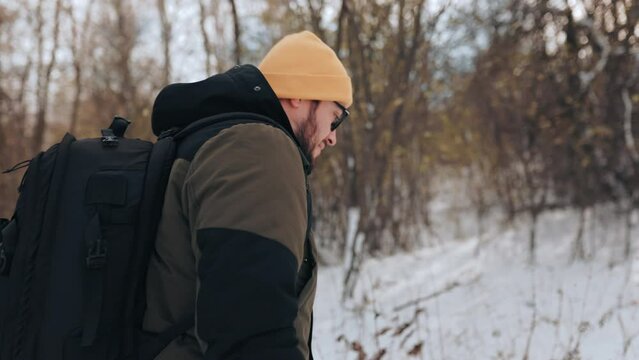 Free Spirit Latino Hiker walk Exploring Winter Wonderland Alone, back view
