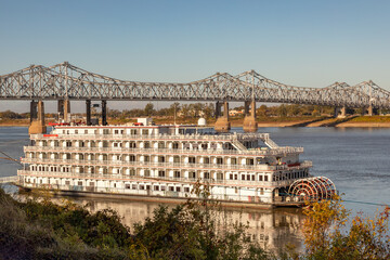 A Paddle Wheeler Passenger Cruise Boat Near the John R Junkin Drive Bridge Over the Mississippi River in Natchez Mississippi - 694572361