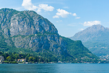 Steep rock face of mountain on edge of lake