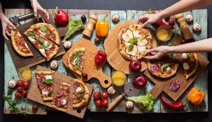 Overhead pizzas with woman and child hands