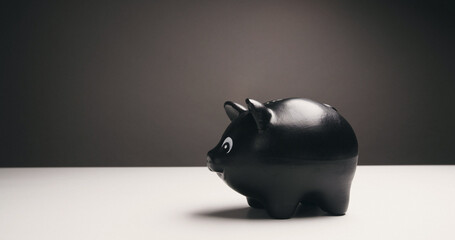 Black piggy bank - financial concept. Saving money, budgeting