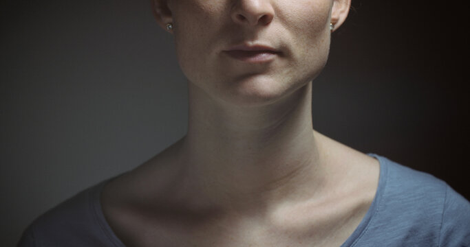 Closeup Portrait Of A Serious Woman In Dramatic Lighting