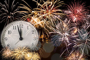 Happy new year conceptual image. New year countdown clock with fireworks in background.