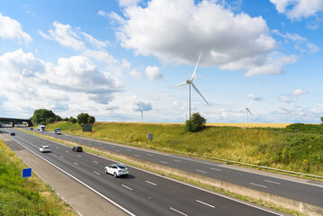 Wind farm along  a motorway in a the countryside of England on a sunny summer day