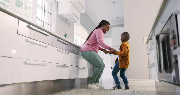 Mother, kitchen and black family child dancing, smile and enjoy quality bonding time together, fun and excited energy. Holding hands, happiness and home mom, mama or African woman teaching young kid