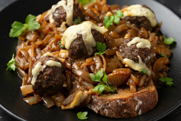 French onion beef meatballs served with sourdough bread on a plate - obrazy, fototapety, plakaty