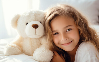 Cute little fair-skinned child girl hugging teddy bear. Love and tenderness. Happy childhood concept.