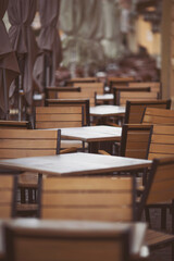 Coffeehouse cafe restaurant terrace. Wooden chairs and tables. Outdoor terrace concept. Shallow...