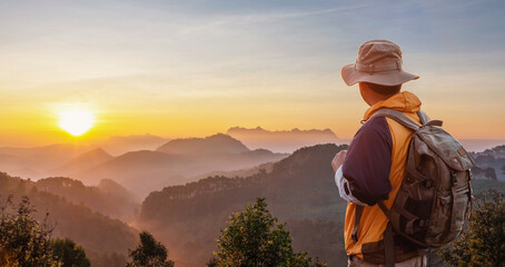 Hiker looking sunlight in trip in thailand country, Hipster young man with backpack enjoying sunset...