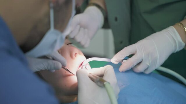 child boy in a dentist's chair treats teeth at dental doctors drill teeth treat caries
